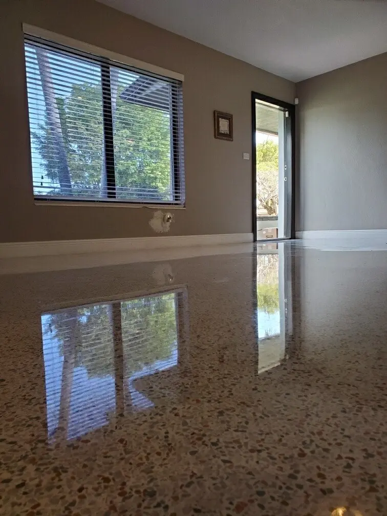 Highly reflective epoxy based terrazzo floor in a residential room with window blinds