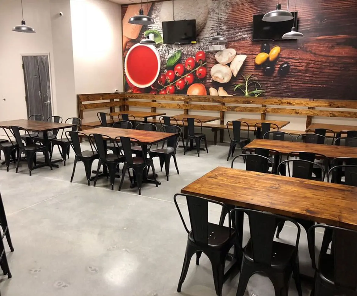 Restaurant dining area with seamless epoxy flooring and food mural backdrop