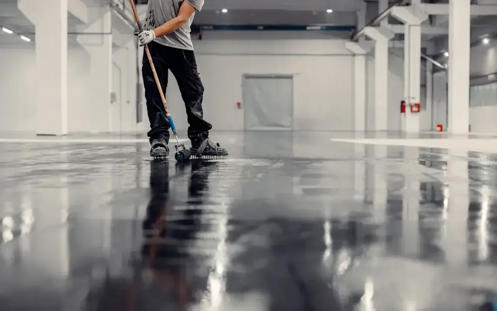 Worker mopping a high-gloss polished concrete warehouse floor