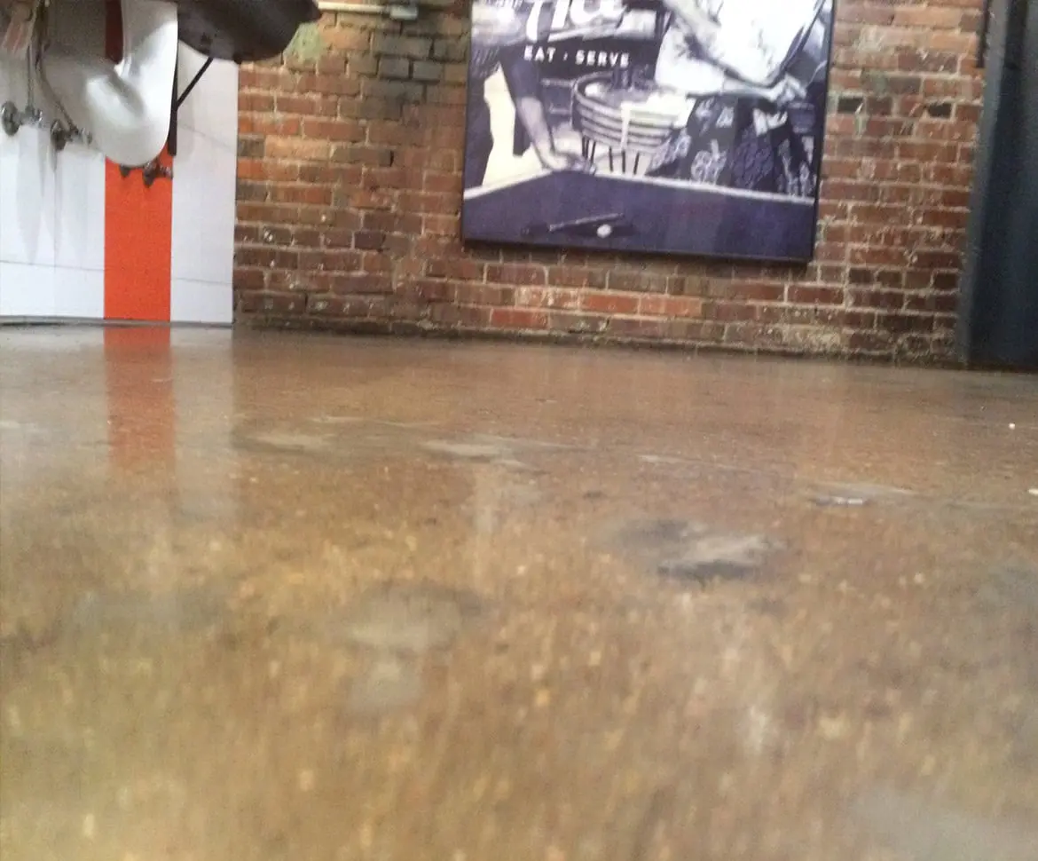 Polished concrete warehouse floor with yellow safety stripe markings