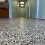 Close-up of epoxy chip flooring with speckled aggregate finish