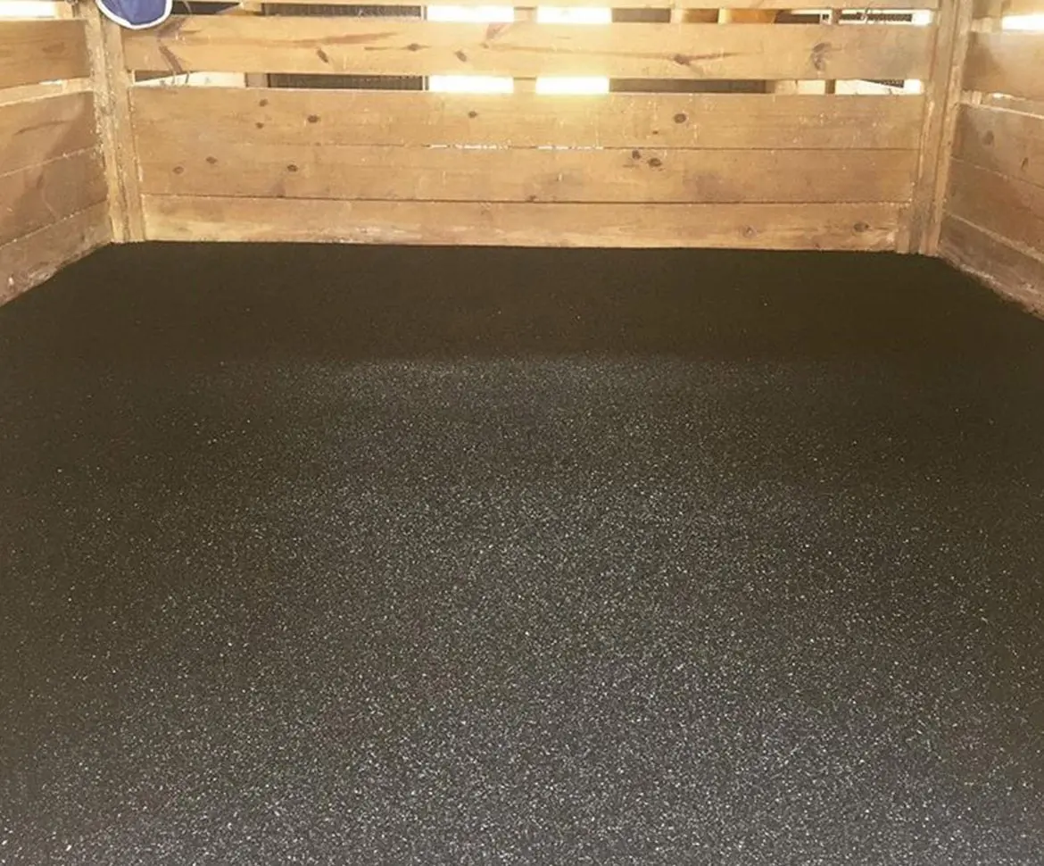 Speckled epoxy chip gym floor with painted basketball court lines in blue and black