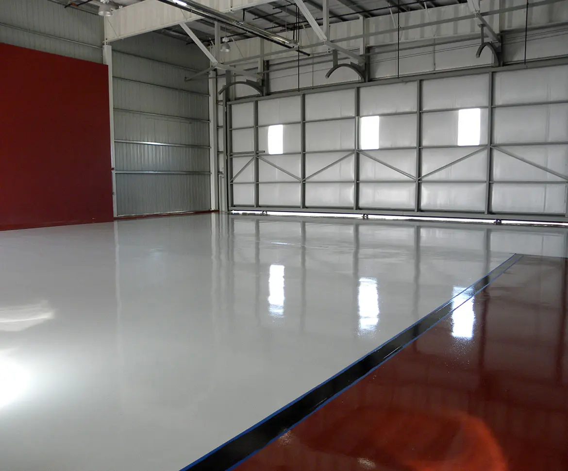 Parking facility with epoxy floor coating and directional arrow striping