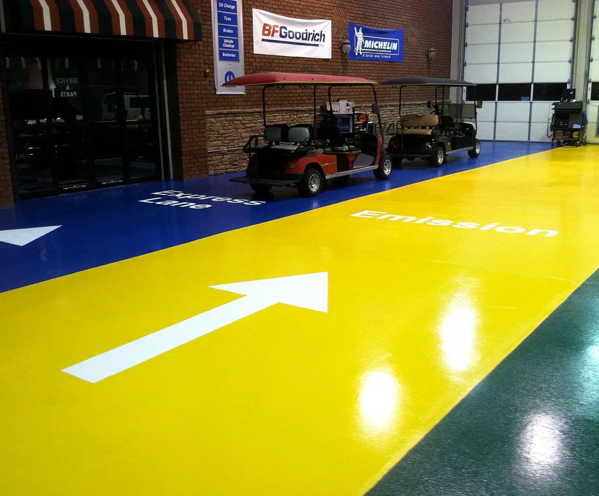 Vehicle facility floor with high-traffic impact-resistant coating